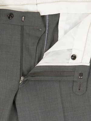 Close-up of dark gray dress pants, inside out, showing the interior lining, zipper, and button. The fabric appears to be a fine weave. The lining is white.