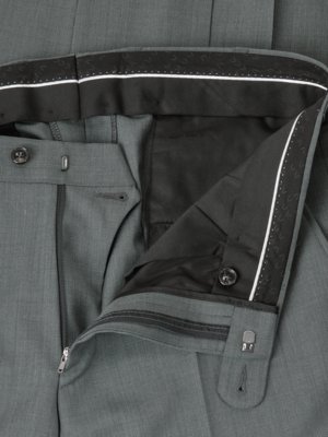 Close-up view of gray dress pants waistband and interior, showing a zipper, buttons, and patterned lining.  The fabric appears to be a textured woven material.