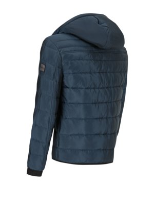Quilted jacket with embroidered label on the sleeve