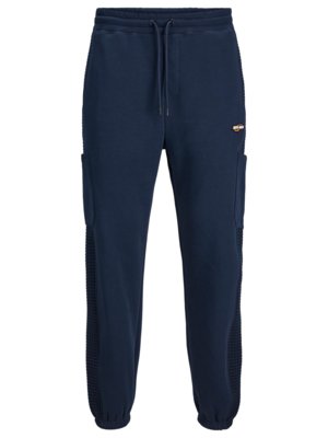 Jogging bottoms with patch pockets on side stripes
