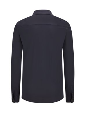 Back view of a dark blue long-sleeved button-down shirt. The collar is upright. The sleeves have buttoned cuffs. The shirt has a seam across the upper back.