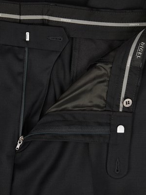 Close-up of the top of black pants with a partially unzipped zipper. The waistband is visible with a button, hook and eye closure and the interior lining is exposed. "Stretch" is printed on the waistband.
