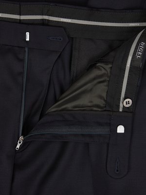 Close-up of a pair of dark blue pants. The zipper is open, revealing the interior lining and buttoned closure. The waistband has "STRETCH" marked on it. A small label says "DIGEL".