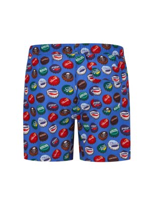 A pair of blue swim trunks covered in a pattern of assorted bottle caps. The bottle caps are red, green, brown, and white, with printed text on them, scattered over the blue fabric.