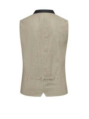 Back view of a beige and black vest on a white background. The vest has a black collar, is made of a patterned fabric and features an adjustable strap with a metal buckle at the waist.