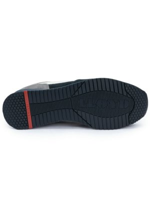 The sole of a sneaker is shown, viewed from the bottom. It is dark gray, with a textured pattern. A red rectangle is on the heel. The sneaker is on a white background.