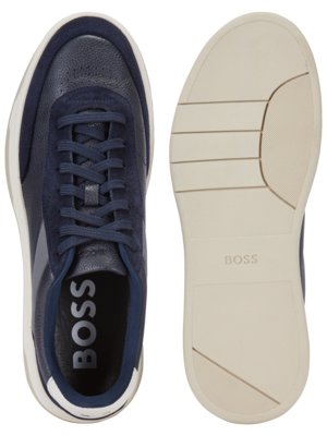 Two navy blue sneakers are displayed on a white background. The left shoe's side profile shows navy leather and suede details with white sole. The right displays the sole, beige with BOSS printed.