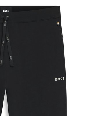 Black BOSS sweatpants with white BOSS branding on the drawstring and a small BOSS logo on the hip.