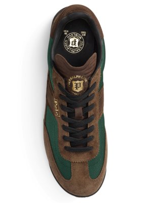 A brown, green, and black Polo Ralph Lauren sneaker is shown from a top-down perspective. The shoe has black laces and a brown suede upper with green mesh accents. The Polo logo is visible.