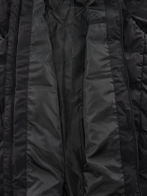 Close-up of the interior of a black jacket. The lining is a shiny, smooth fabric with visible seams creating vertical panels. The jacket is open, revealing the inside structure.