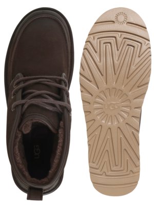 A pair of brown UGG boots. The left boot is shown from above, revealing laces and fur lining. The right boot shows the light brown sole with a textured design and the UGG logo.