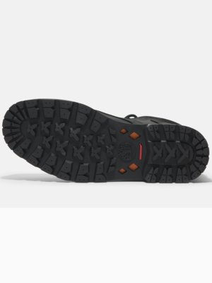Close-up view of the black rubber sole of a Timberland boot with an intricate tread pattern and orange diamond accents.