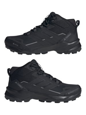 Two black Adidas Terrex mid-top hiking boots. The boots feature three stripes on the side, "TERREX" printed on the side, and "GORE-TEX" near the toe. The soles have a textured pattern.