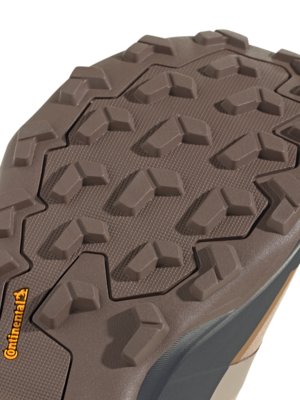 Close-up shot of the sole of a brown shoe. The sole has a textured pattern of raised, irregular shapes. The Continental logo is visible on the side of the sole, in orange lettering.