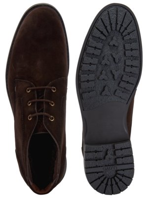 Overhead view of a brown suede boot next to its sole. The boot is laced and rounded at the toe. The sole is dark with a patterned tread. The background is white.