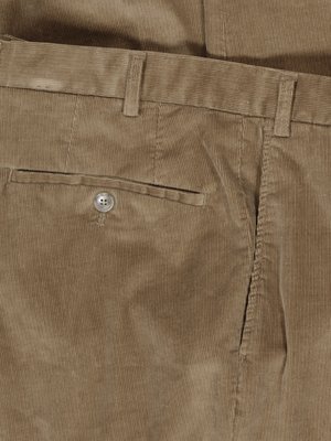 Close-up shot of the back of tan corduroy trousers. The image shows a back pocket with a button, belt loops, and the waistline. The fabric has a vertical ribbed texture.