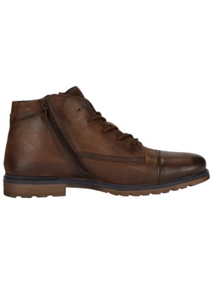 A brown leather boot, viewed from the side, is laced and features a zipper on the side. The boot has a cap toe, a dark brown sole, and a short, ankle-high design.