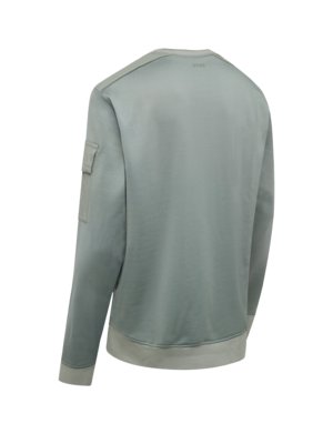 A pale green sweatshirt is displayed against a white background. The sweatshirt has a crew neck and a small pocket on the left sleeve. The brand "BOSS" is visible near the neck. The bottom hem and the cuffs are a lighter shade of green.