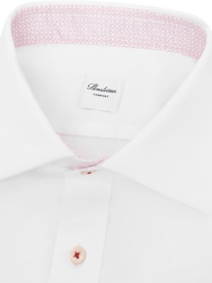 Close-up of a white dress shirt with a patterned pink collar lining. The shirt has a label that reads "Stenströms Comfort." A button is visible on the placket, as well as a small amount of pink stitching.