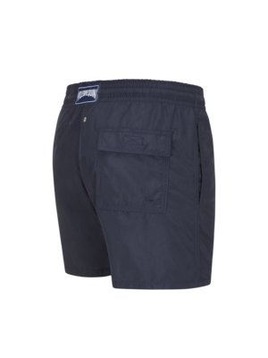 Swim trunks with label patch on the waistband