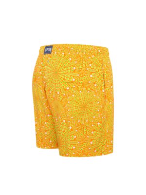 Orange swim shorts with a yellow and white abstract radial pattern, featuring a navy blue logo patch on the waistband.