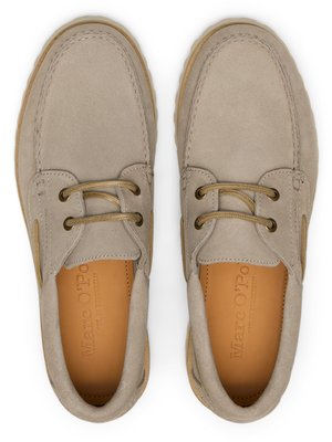 Overhead shot of two beige suede boat shoes. The shoes have brown laces and soles. The insoles have the brand name "Marc O'Polo". The shoes appear unworn.