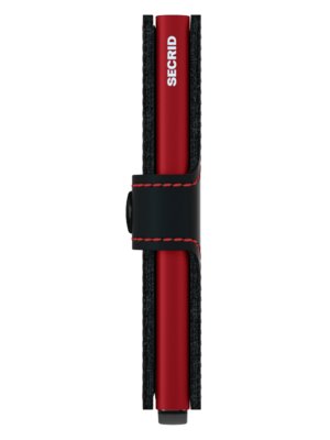 A vertical image of a red Secrid card holder. The holder is encased in black fabric on both sides. A black leather strap with red stitching wraps around it, secured with a small black button. The word "SECRID" is printed vertically on the red card holder.