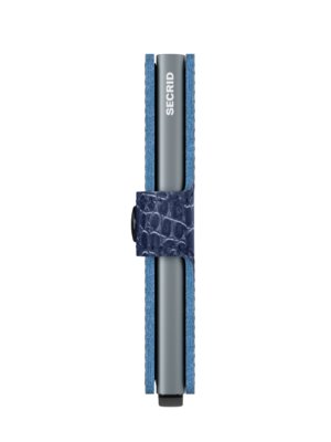 A vertical product shot of a Secrid wallet. The wallet is a light blue color with a dark blue band that wraps around it. The band has a pattern on it. The wallet itself is silver, and the word "Secrid" is visible on the front.