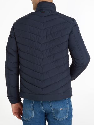 Quilted jacket with logo patch on the sleeve