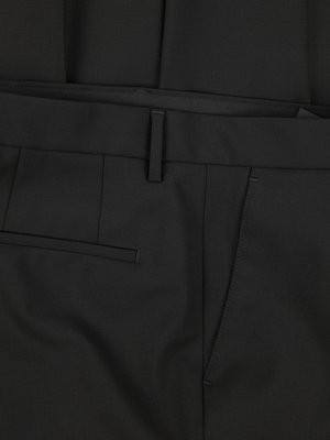 Close-up view of black dress pants. Visible are the waistband, belt loop, and front pocket. The fabric has subtle texture, and the stitching is visible. A front side pocket is also displayed.