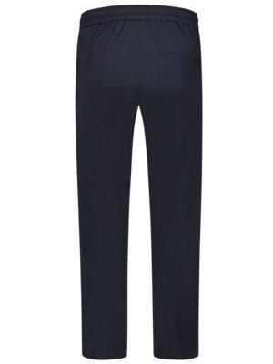 Dunkelblaue Sporthose von hinten fotografiert. Der Schnitt ist gerade. Oben am Bund ist ein Gummizug zu erkennen. Auf der rechten Seite ist eine Gesäßtasche.